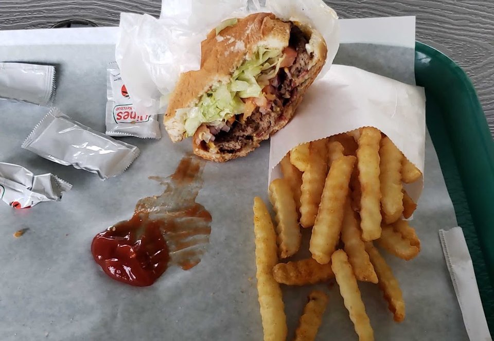Printed menu with cheeseburgers and sandwiches.