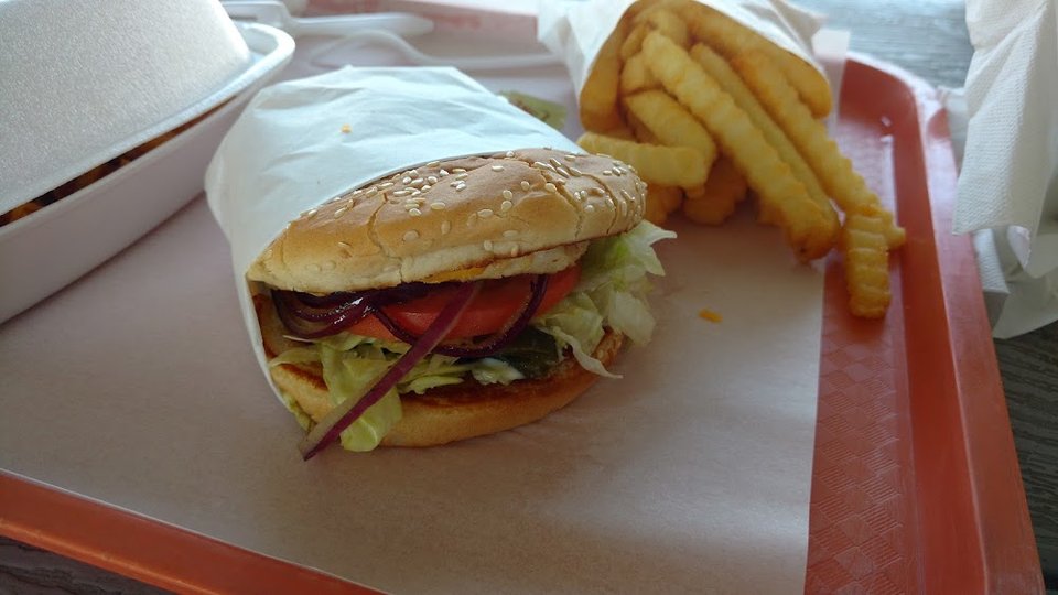 Printed menu with cheeseburgers and sandwiches.