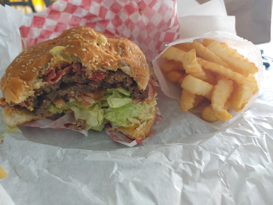 Menu board showing burgers and combo meals.