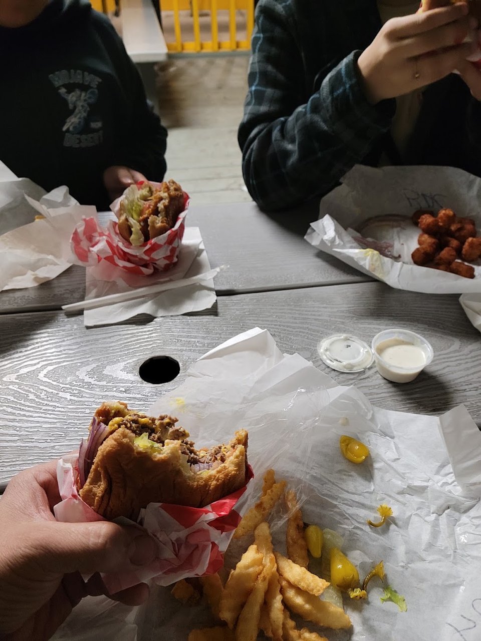 Printed menu with cheeseburgers and sandwiches.