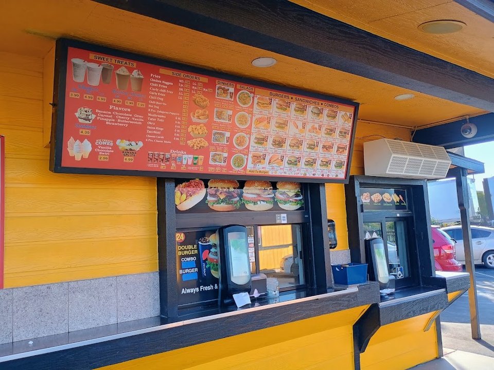 Printed menu with cheeseburgers and sandwiches.