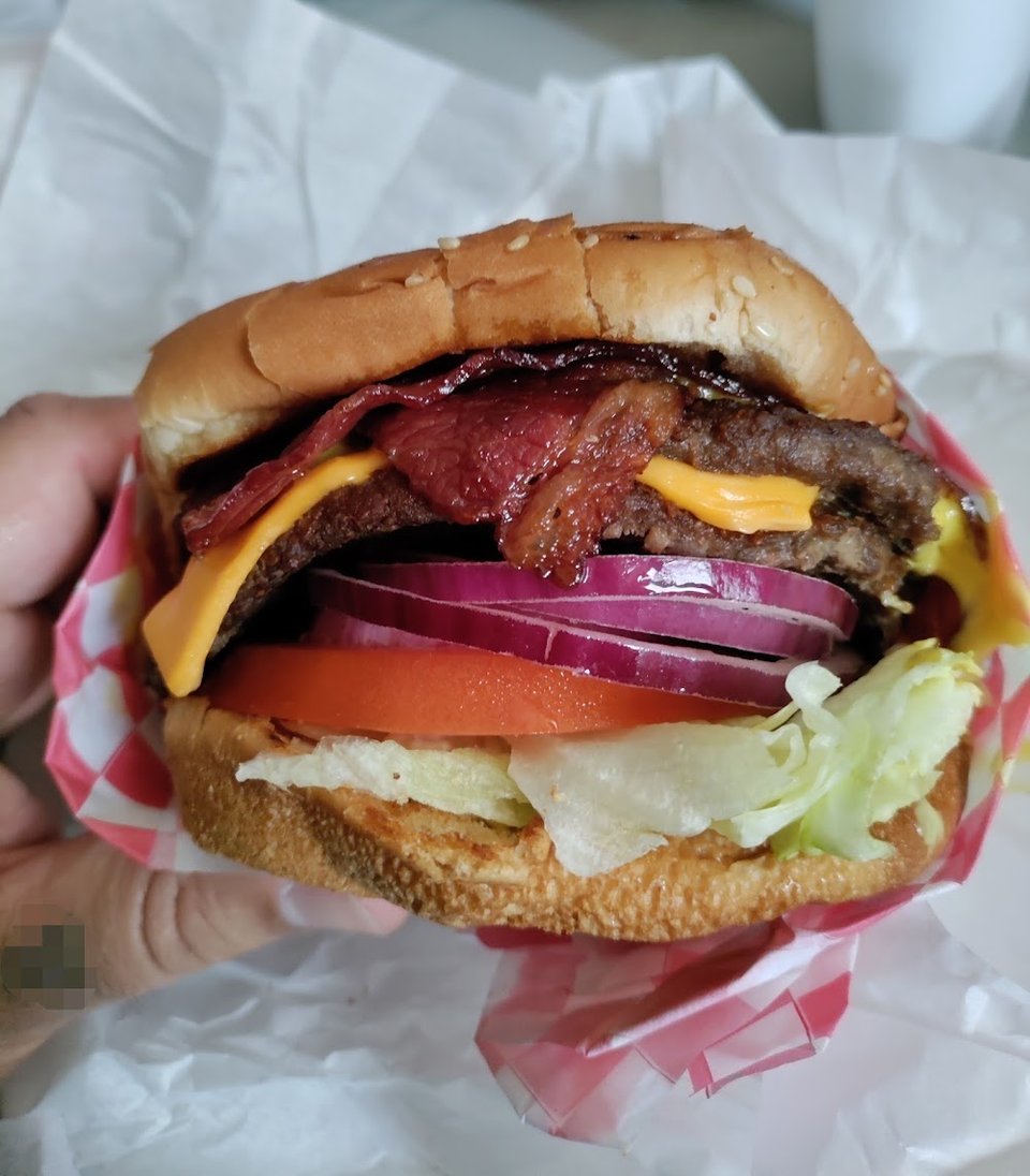 Menu board showing burgers and combo meals.