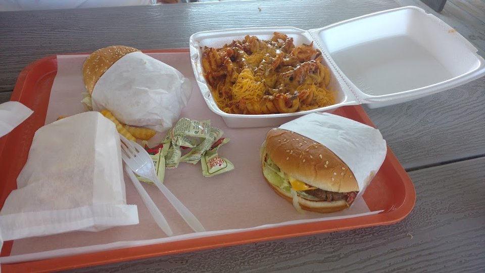 Printed menu with cheeseburgers and sandwiches.